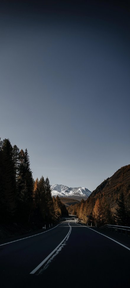 Phone wallpapers: roads, snowy mountains, forests, gray skies