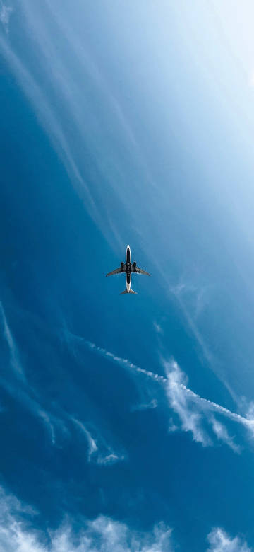 Airplane Flying High in the Clear Blue Sky Wallpaper