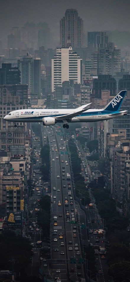Spectacular Airplane Landing Near Skyscrapers 4K Wallpaper