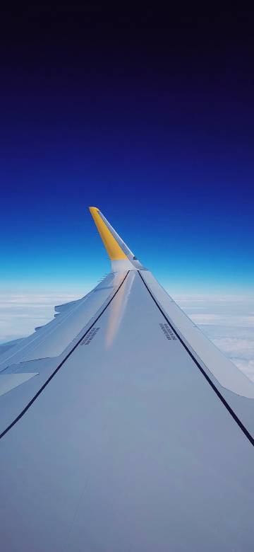 Deep Blue Sky with Airplane Wing 4K Phone Wallpaper
