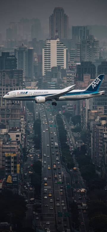 Spectacular Airplane Landing Near Skyscrapers 4K Wallpaper