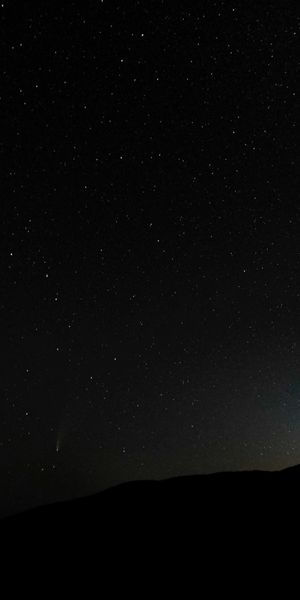 Starry Night Sky Over a Dark Hill