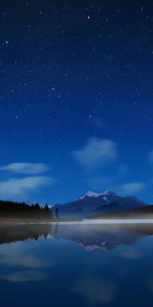 Tranquil Night Landscape: Lake, Mountains, and Starry Sky Phone Wallpaper