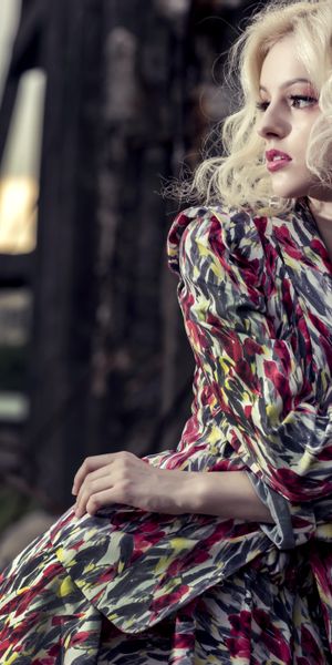 Charming blonde model in a colorful robe against an urban backdrop, 4K wallpaper