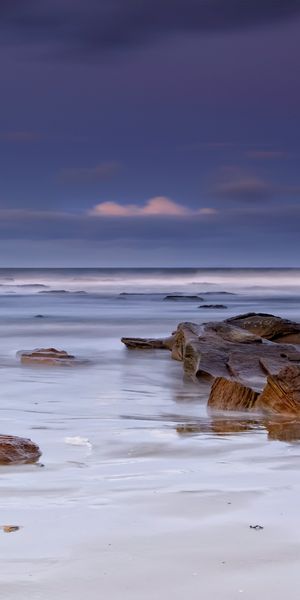 Serene Beach Scene with Stones Perfect for Mobile Wallpaper