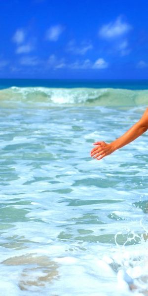 Beautiful Woman in Bikini Running into Ocean Waves on the Beach