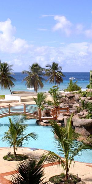 Beautiful tropical resort wallpaper with palms, pools, and ocean views