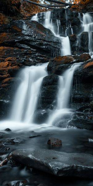 Breathtaking Waterfall Cascading Over Stones