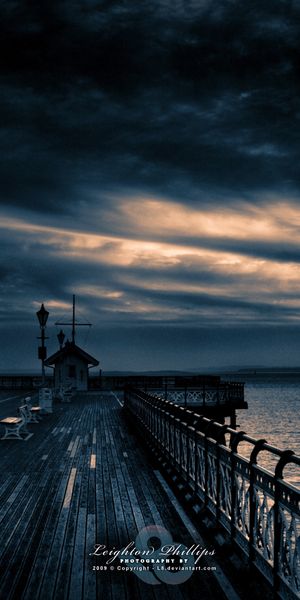 Tranquil pier scene at sunset - Ideal 4K iPhone wallpaper