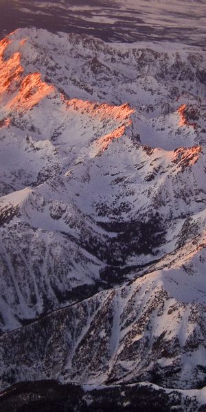 Breathtaking aerial view of snow-covered mountains at sunset - 4K mobile wallpaper