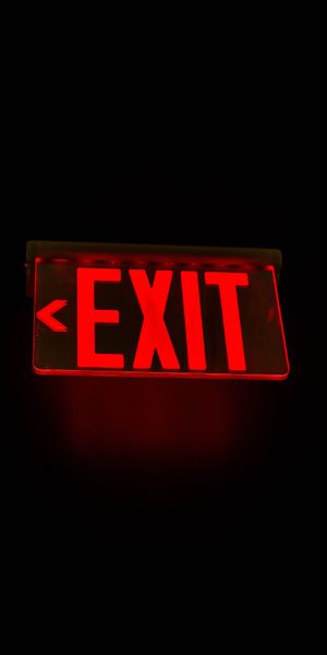 Ultra HD Red EXIT Sign with Backlight on Dark Background