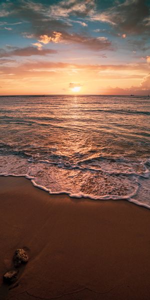 Serene Sunset Over the Beach with Gentle Waves