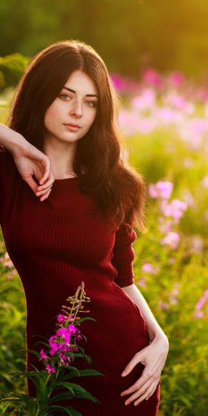 Trendy Brunette in Red Dress Surrounded by Nature