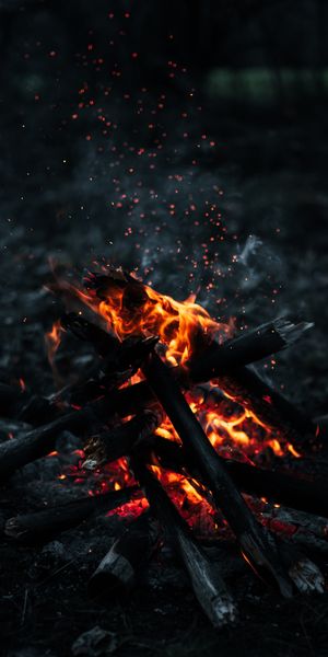 Dark Bonfire with Sparks and Smoke Wallpaper