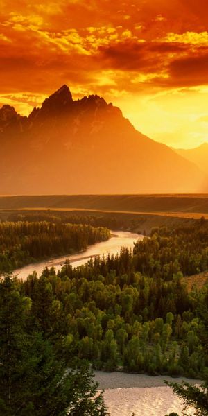 Breathtaking 4K phone wallpaper featuring a river, forest, and sunset mountains