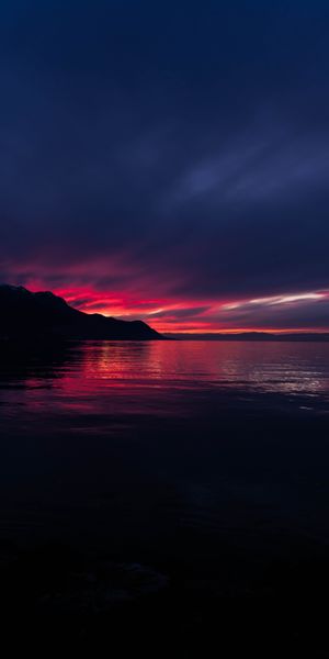 Breathtaking HD phone wallpaper of a sunset over Swiss mountains and sea