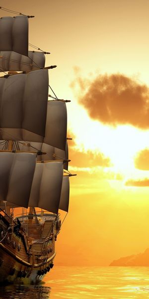 Majestic sailing ship against a vibrant sunset background over the ocean