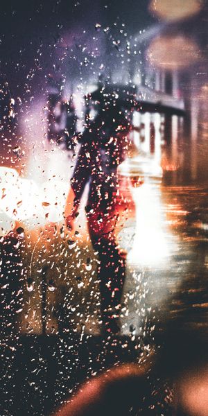Captivating phone wallpaper featuring a blurred silhouette and raindrops