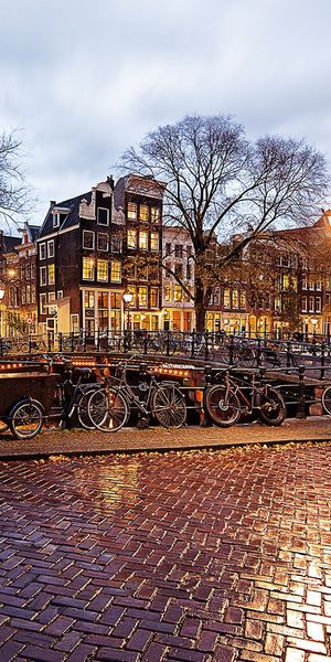 4K Wallpaper of Amsterdam: Rainy Reflections and Bicycles at Dusk