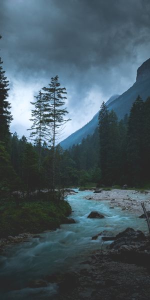 Twilight Landscape Featuring Majestic Mountains and a Serene River
