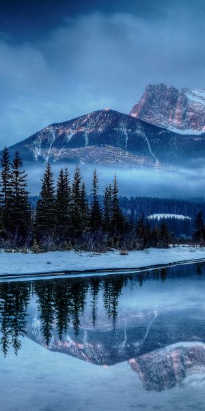 Breathtaking Winter Landscape with Snowy Mountains and Lake Reflection