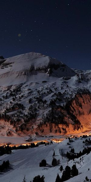 Enchanting Winter Landscape: Austrian Village and Mountains at Night for iPhone Wallpaper