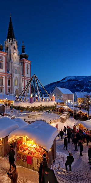 Enchanting Night View of a Christmas Market in a Snowy City