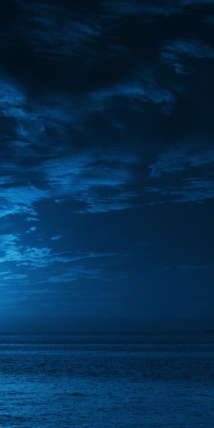Serene Night Ocean Scene with Full Moon and Clouds