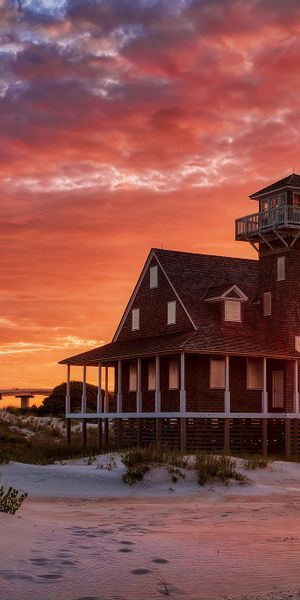 Phone wallpaper: Sunset, Beach, Sand, House, Lighthouse, Cloud, Sunbeam, Man Made free download