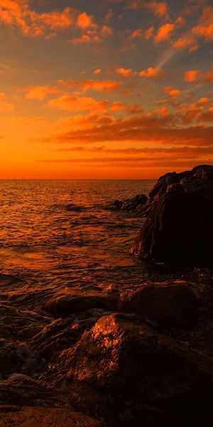 Breathtaking Sunset Over the Sea with Rocky Stones