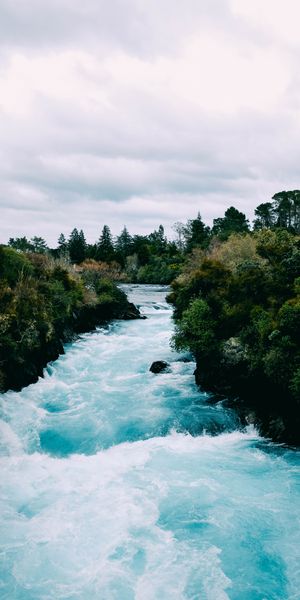 Vibrant River Flowing Through Greenery