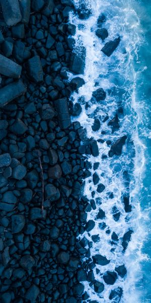 Aerial View of Rocky Shore and Ocean Waves