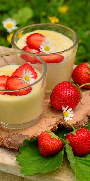 Charming mobile wallpaper featuring yogurt and strawberries in a floral setting