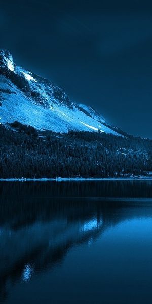 Enchanting winter lake scene with moon and forest - Free Phone Background