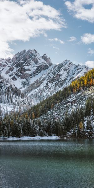 Breathtaking Snowbound Mountains and Serene Lake Wallpaper