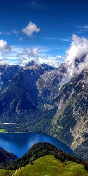 Breathtaking View of Mountains and Blue Waters Under Clouds