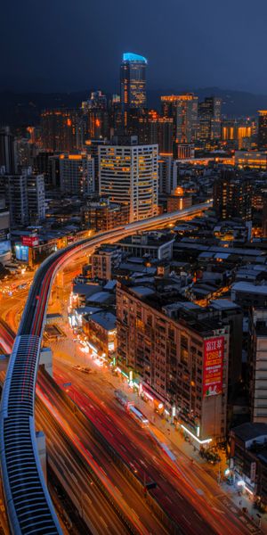 Vibrant Night Cityscape with Illuminated Skyscrapers