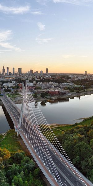 Breathtaking Sunset View of a City Bridge Surrounded by Nature
