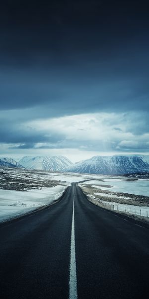 Magical Nighttime Winter Road Surrounded by Mountains
