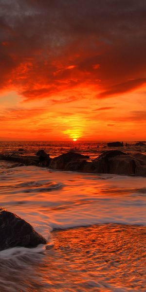 Breathtaking sunset wallpaper featuring the earth and ocean, ideal for phones