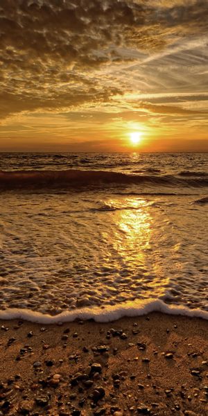 Beautiful Sunset Over the Sea Waves at the Beach