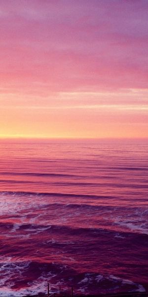 Breathtaking lighthouse scene at sunset over the ocean - perfect phone wallpaper