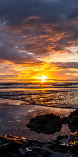 Beautiful Sunset Over the Ocean with Stones
