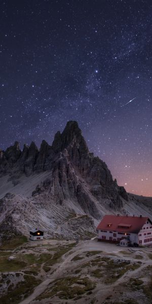 Starry Sky Over Mountains with Charming Houses