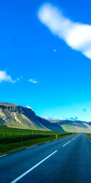 Breathtaking Mountain Road with Vibrant Sky