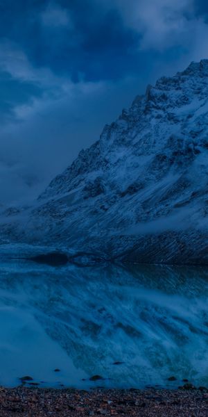 Majestic Winter Scene with Moonlit Reflection in a Mountain Lake