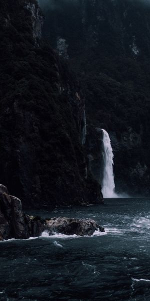 Majestic Waterfall Cascading from Cliff into the Sea