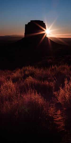 Breathtaking sunset landscape wallpaper featuring a rocky silhouette