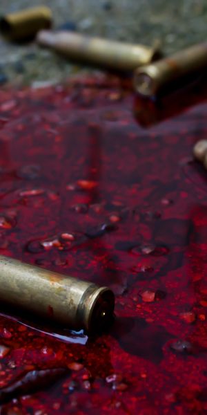 Intriguing Dark Background Featuring Blood and Shell Casings for Impactful Decor