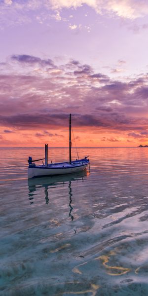 Tranquil Ocean Sunset with Boat - Ideal 4K Phone Background